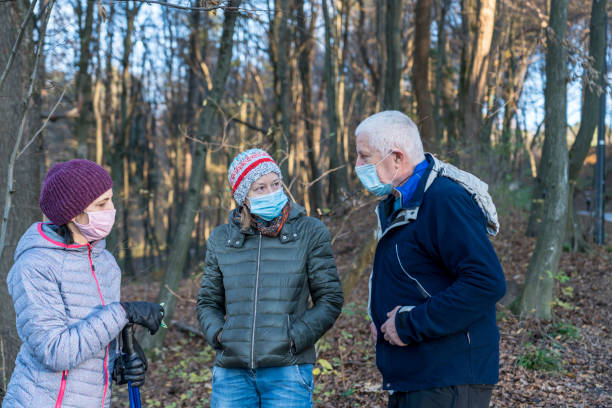 People wearing protective face mask in the forest stock photo