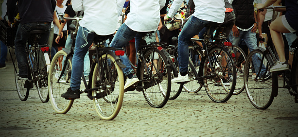 many people who ride bicycles in a northern europe city with vintage effect