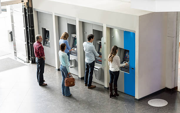 People withdrawing cash at an ATM Group of Latin American people withdrawing cash at an ATM bank financial building stock pictures, royalty-free photos & images