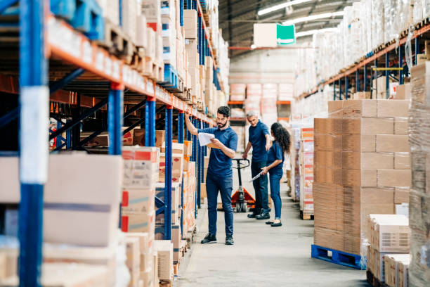People working in a large distribution warehouse stock photo