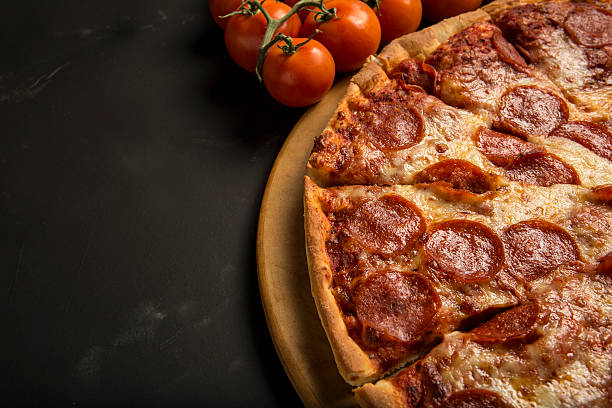 Pepperoni and cheese Pizza and tomatoes with copy area stock photo