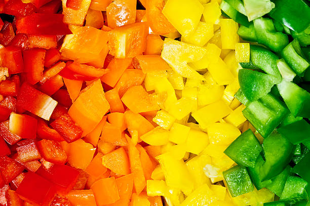 Peppers "Full frame background / texture of chopped red, orange, yellow, and green bell peppers." chopped food stock pictures, royalty-free photos & images