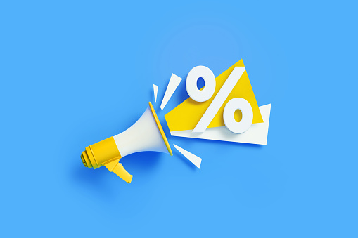 Percentage sign coming out from a yellow megaphone on blue background. Horizontal composition with copy space. Great use for sale and percent concepts.
