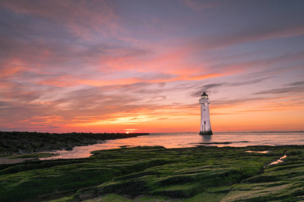 Perch Rock Lighthouse New Brighton Sunset image of New Brighton lighthouse or Perch Rock which  is situated on the River Mersey and Liverpool Bay confluence. the wirral stock pictures, royalty-free photos & images