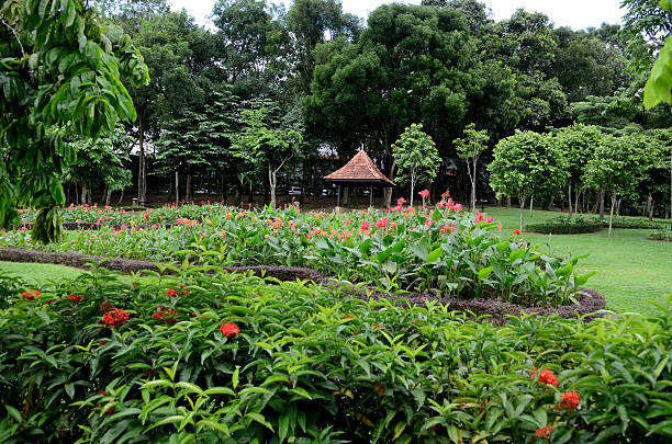 Perdana Botanical Garden Kuala Lumpur, Malaysia - September 14, 2012: Glade with flower beds and arbors at Perdana Botanical Gardens  in Kuala Lumpur, Malaysia. perdana botanical garden stock pictures, royalty-free photos & images
