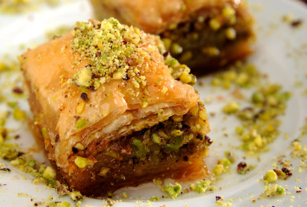 Perfect baklava with pistachio arranged on a white plate stock photo