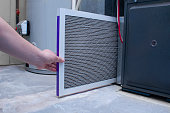 istock A person changing an air filter on a high efficiency furnace 1308363658