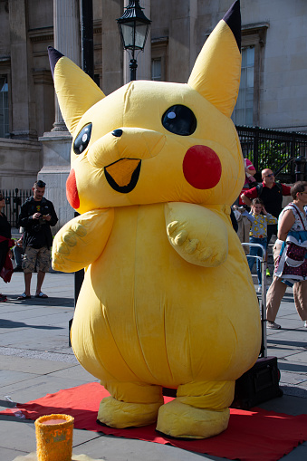 person-dressed-in-an-inflatable-pikachu-costume-to-entertain-pokemon-picture-id1205982318