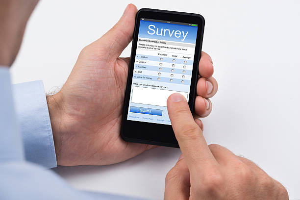 Close-up Of Person Filling Online Survey Form On Mobile Phone