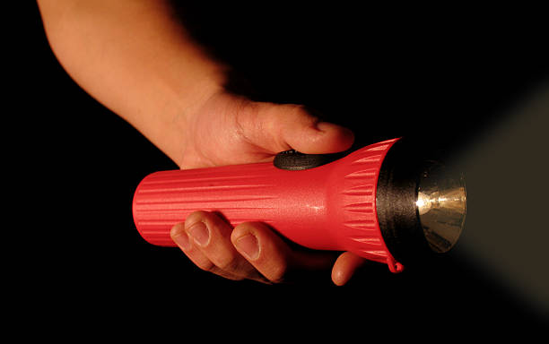 Person Holding Red Flashlight stock photo