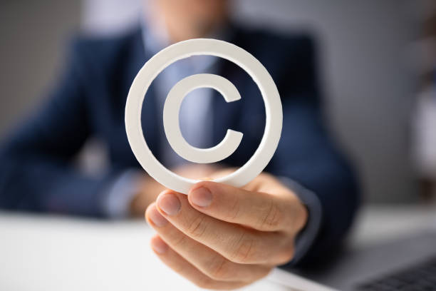 Person Holding White Copyright Sign Person Holding White Copyright Sign In Hand intellectual property stock pictures, royalty-free photos & images