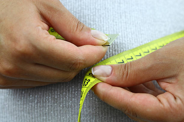 Person measuring their waste line stock photo