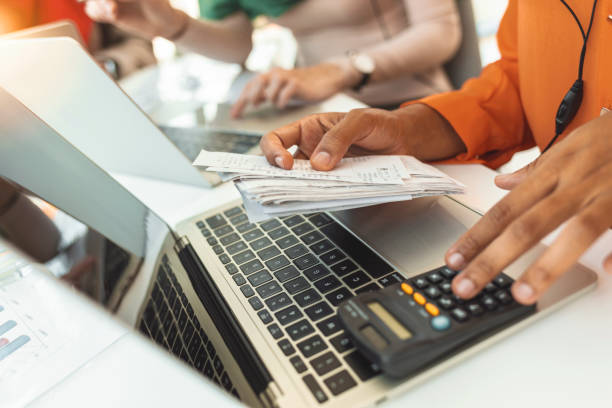 Person paying invoice to computer