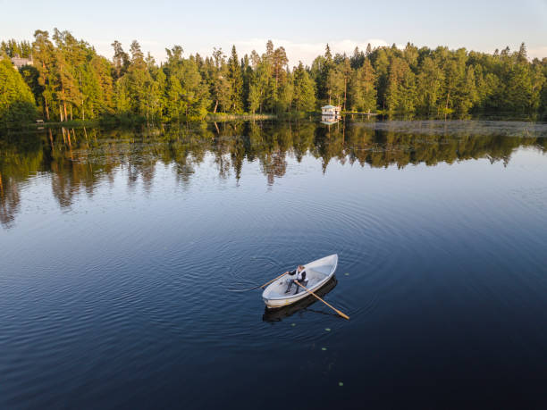 Person rowing in the lake Gallträsk in southern Finland. stock photo