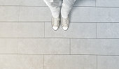 istock Person taking photo of his feet stand on concrete floor 617744968