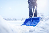 istock Person using a snow shovel in winter 1346723440