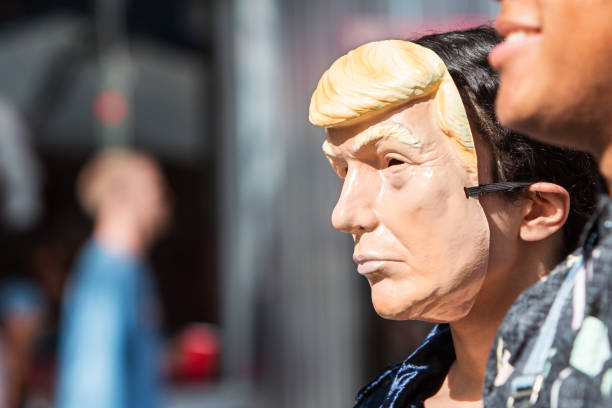 Person Wears Donald Trump Mask At Atlanta Halloween Parade A person wears a Donald Trump mask at the Little Five Points Halloween Parade on October 21, 2017 in Atlanta, GA. donald trump stock pictures, royalty-free photos & images