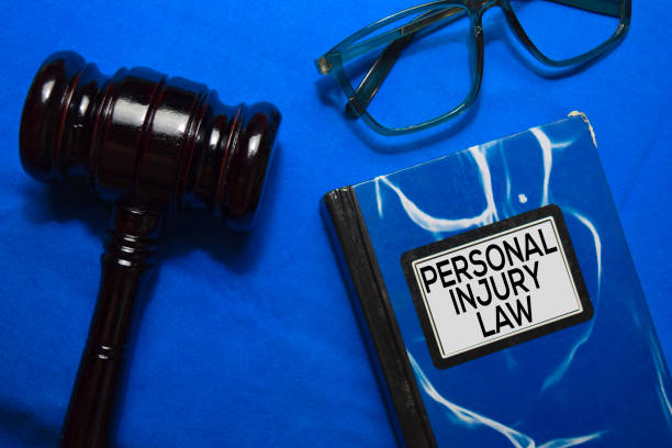 Personal Injury Law text on Book and gavel isolated on office desk. Personal Injury Law text on Book and gavel isolated on office desk. personal injury lawyer stock pictures, royalty-free photos & images
