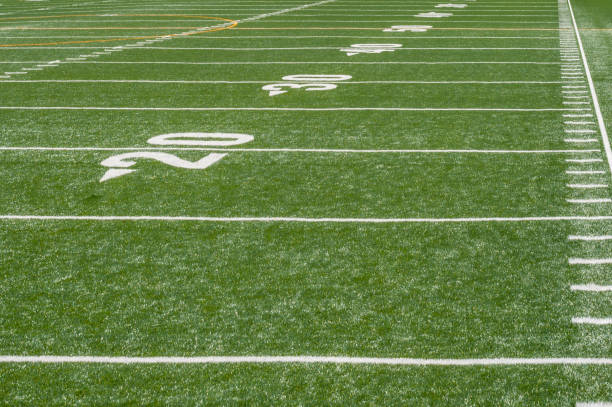 perspective view of marker lines down empty football field  football field stock pictures, royalty-free photos & images