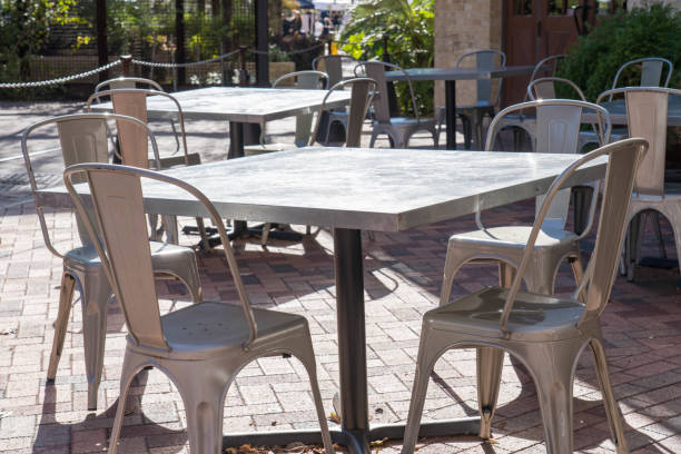 Perspective View of Metal Chairs and Tables Outdoors stock photo