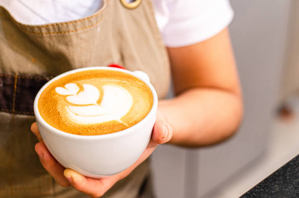 Peruvian female barista create latte art in coffee shop Peruvian female barista create latte art in coffee shop, food and drink concept hot peruvian women stock pictures, royalty-free photos & images