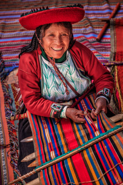 Peruvian woman weaving in The Sacred Valley, Chinchero The Sacred Valley of the Incas or Urubamba Valley is a valley in the Andes  of Peru, close to the Inca capital of Cusco and below the ancient sacred city of Machu Picchu. The valley is generally understood to include everything between Pisac  and Ollantaytambo, parallel to the Urubamba River, or Vilcanota River or Wilcamayu, as this Sacred river is called when passing through the valley. It is fed by numerous rivers which descend through adjoining valleys and gorges, and contains numerous archaeological remains and villages. The valley was appreciated by the Incas due to its special geographical and climatic qualities. It was one of the empire's main points for the extraction of natural wealth, and the best place for maize production in Peru.http://bem.2be.pl/IS/peru_380.jpg beautiful peruvian women stock pictures, royalty-free photos & images