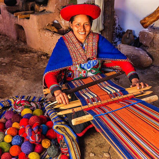 Peruvian woman weaving, The Sacred Valley, Chinchero Peruvian woman weaving in Chinchero. The Sacred Valley of the Incas or Urubamba Valley is a valley in the Andes  of Peru, close to the Inca capital of Cusco and below the ancient sacred city of Machu Picchu. The valley is generally understood to include everything between Pisac  and Ollantaytambo, parallel to the Urubamba River, or Vilcanota River or Wilcamayu, as this Sacred river is called when passing through the valley. It is fed by numerous rivers which descend through adjoining valleys and gorges, and contains numerous archaeological remains and villages. The valley was appreciated by the Incas due to its special geographical and climatic qualities. It was one of the empire's main points for the extraction of natural wealth, and the best place for maize production in Peru.http://bem.2be.pl/IS/peru_380.jpg beautiful peruvian women stock pictures, royalty-free photos & images