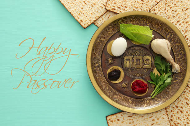 Pesah celebration concept (jewish Passover holiday) Pesah celebration concept (jewish Passover holiday). Traditional pesah plate with five symbols: horseradish, celery, egg, bone, maror, charoset. Text in hebrew: Passover passover stock pictures, royalty-free photos & images