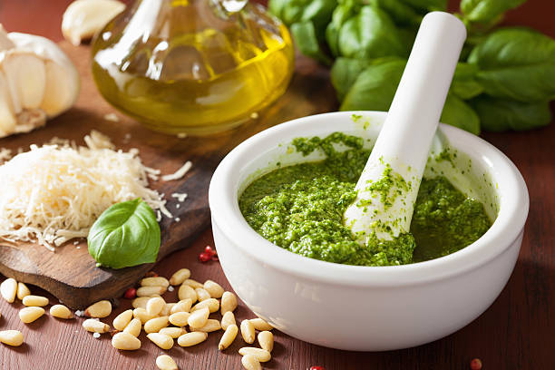 pesto sauce and ingredients over wooden rustic background stock photo