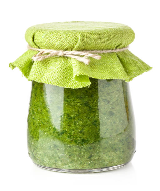 Pesto sauce isolated on white Pesto sauce isolated on white green olives jar stock pictures, royalty-free photos & images