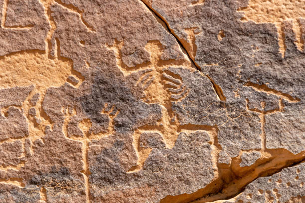 A petroglyphic image of humans with anatomical details on the Graffiti Rock (Qaryat al Asba) stock photo