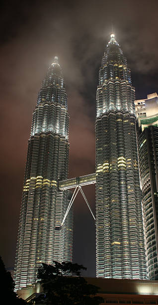 Petronas Towers At Night Night view of the Petronas Twin Towers in Kuala Lumpur, Malaysia. central market kuala lumpur stock pictures, royalty-free photos & images