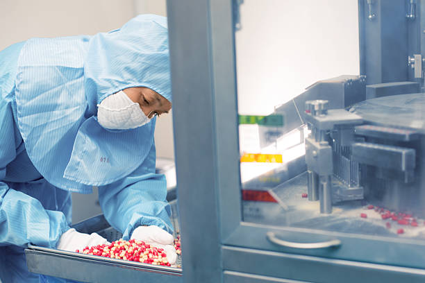 pharmaceutical factory worker stock photo