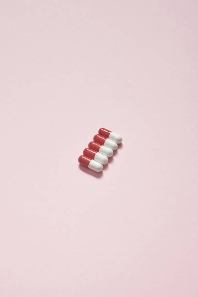 Pharmaceutical tablets over pink background. stock photo