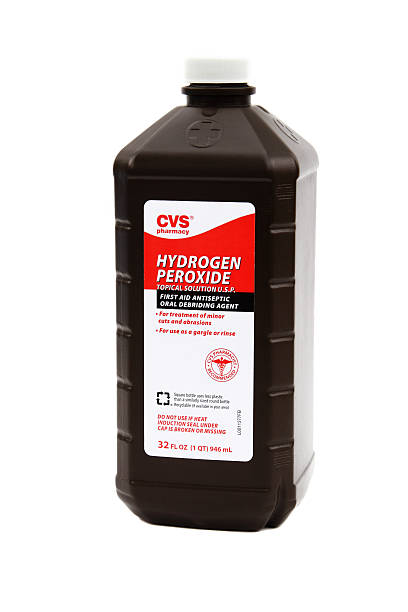 CVS Pharmacy brand Hydrogen Peroxide. "West Palm Beach, USA - March 11, 2013: A container of CVS Pharmacy brand Hydrogen Peroxide, a topical solution used as a first aid treatment antiseptic. This liquid solution is used to treat minor cuts and abrasions. It can also be used as an oral rinse or gargle. CVS Pharmacy is a major chain of drug stores in the USA." hydrogen peroxide stock pictures, royalty-free photos & images