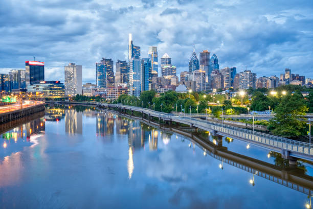 Philadelphia City Skyline at Sunset with a Reflection in the Schuylkill River in Pennsylvania USA stock photo