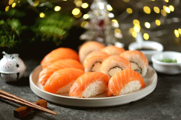 Philadelphia homemade sushi rolls and nigiri sushi with wild salmon,  christmas background. stock photo