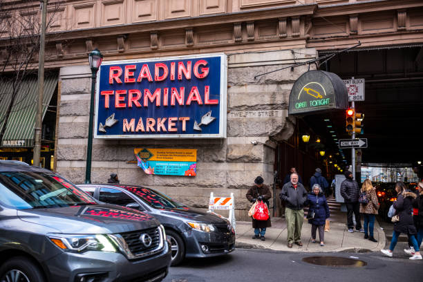 Philadelphia, PA/USA-Feb 29, 2020: Patrons shop at the Reading Terminal Market, an enclosed public market located at Center City Philadelphia. It opened originally in 1893 under the elevated train shed of the Reading Railroad Company. stock photo