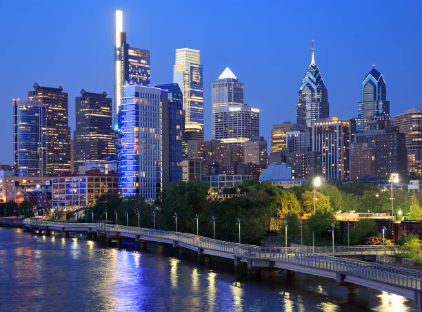 Philadelphia skyline at night with the Schuylkill River on the foreground stock photo