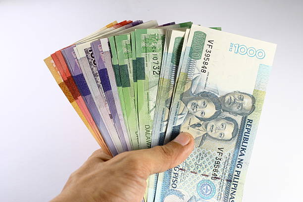 Philippine Peso Bills Held in Hand stock photo