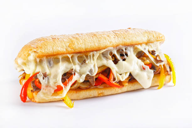 Philly cheese steak sandwich with roasted beef, pepper, caramelized onion, mushrooms and melted cheese on a white background stock photo