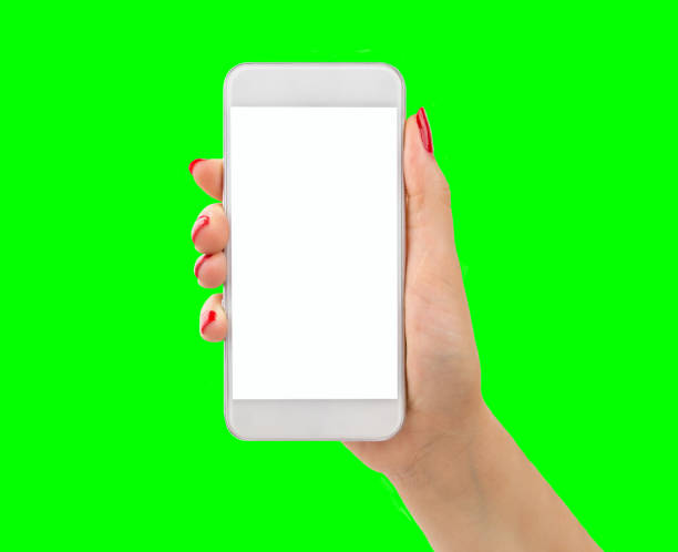phone with chrome key Woman with white smart phone on isolated cutout on green background and chroma key painting fingernails stock pictures, royalty-free photos & images
