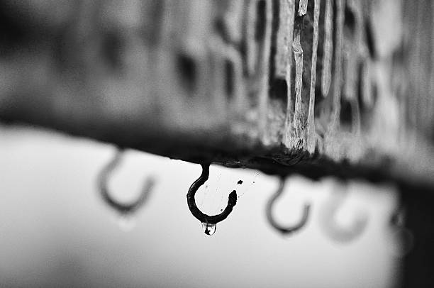 Photo of a droplet of water hanging from a hook stock photo