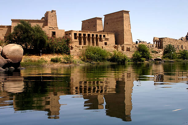 Photo of a Philae temple next to a body of water Egypt: Philae temple from nile aswan egypt stock pictures, royalty-free photos & images