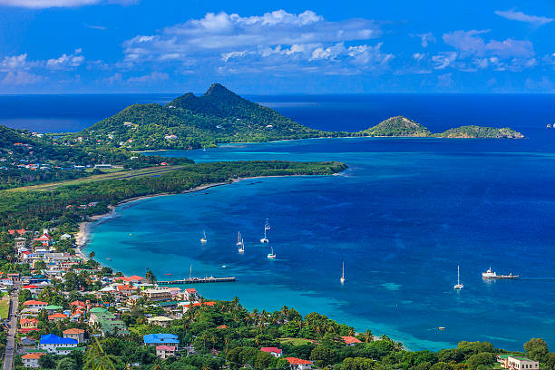 Photo of Belair, Carriacou stretch of beaches From the hill of Belair, the site of the Carriacou hospital, you can have a breathtaking view of the town of Hillsborough and its beautiful bay. Some old rusty cannons are pointed on the bay. Carriacou, Grenada W.I.  caribbean culture stock pictures, royalty-free photos & images