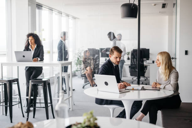 Photo of business partners working in a bright office stock photo