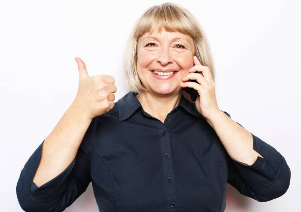 photo of crazy ecstatic old woman use smartphone impressed social media like feedback win raise fists scream yes isolated over white background - sms imposter elderly bildbanksfoton och bilder