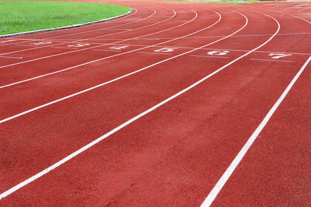 Photo of red running track for competition or exercise, as background. Sports concept. Colorful tone. stock photo