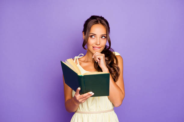 Photo of thoughtful pensive planning lovely charming she her lady biting lips touching chin enjoying free time having fun wearing summer dress isolated violet background Photo of thoughtful pensive planning lovely charming she her lady biting lips touching chin enjoying free time having fun wearing summer dress isolated violet background. romance book cover stock pictures, royalty-free photos & images