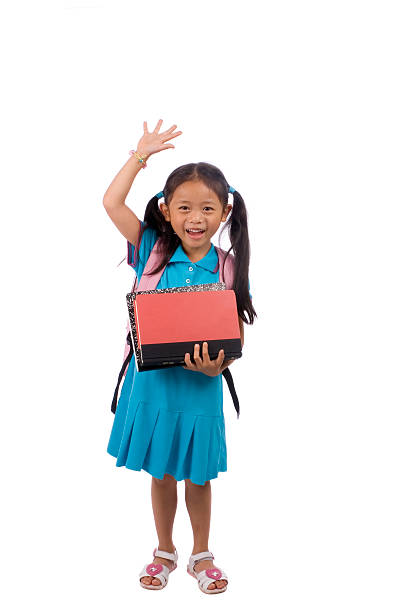 Photo of young student standing and raising her hand stock photo